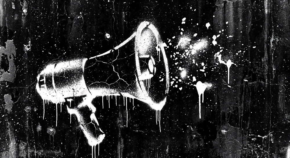 Stencil art of a cracked megaphone